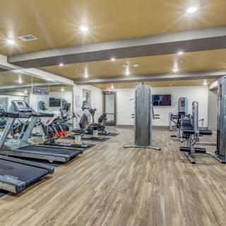 A modern gym equipped with treadmills and various exercise machines.