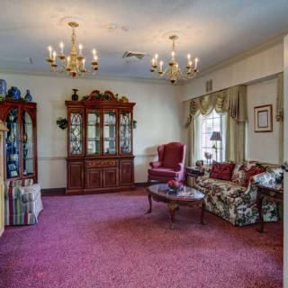 A classic living room with ornate furniture and elegant chandeliers.