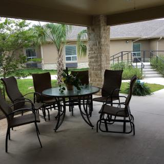 A cozy outdoor patio area with a table and chairs, perfect for relaxation.