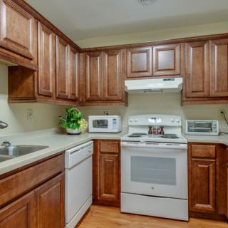 A cozy kitchen with wooden cabinets and modern appliances.