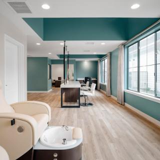 A modern and inviting nail salon featuring spacious interiors, soothing colors, and ample natural light.