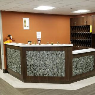 A modern reception area featuring a stylish desk with unique stone detailing.