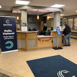 A welcoming reception area with a visitor sign and a registration desk.