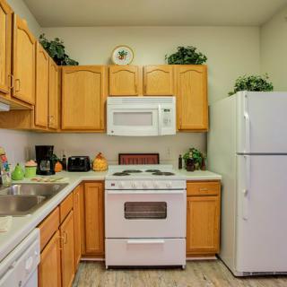 A cozy kitchen with wooden cabinets and standard appliances.