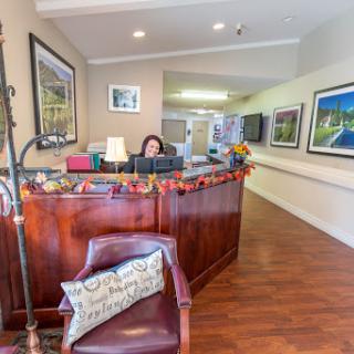 A cozy reception area with a welcoming front desk and decorative artwork.