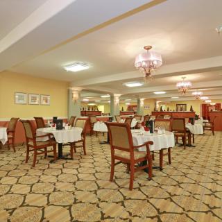 An elegant restaurant dining area with neatly arranged tables and chairs.