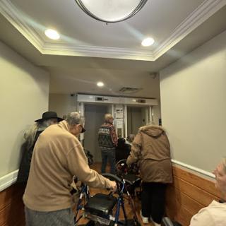 Residents moving through the hallway of a care facility.