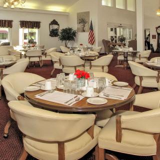 A well-appointed dining area with elegant tables set for a formal meal.