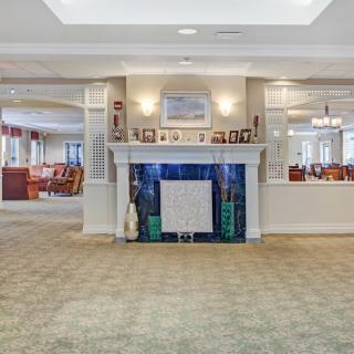 A cozy living room area with a central fireplace and comfortable furnishings.