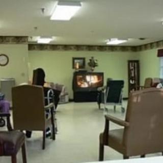A cozy living room with chairs and a television.