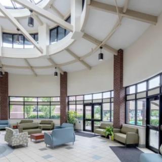 A modern lobby with comfortable seating and large windows providing natural light.