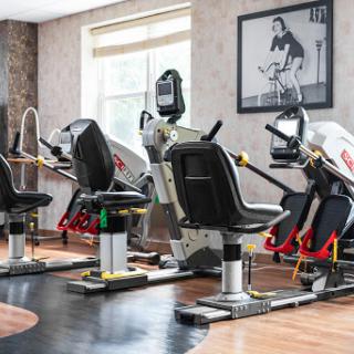 A modern gym setup featuring various exercise machines designed for strength training and cardio workouts.