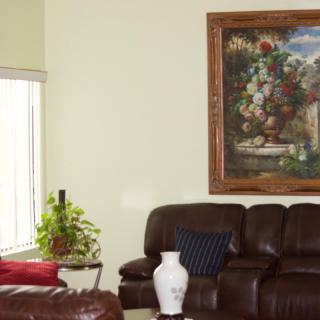 A cozy living room featuring a leather sofa, a decorative painting, and tasteful home accents.