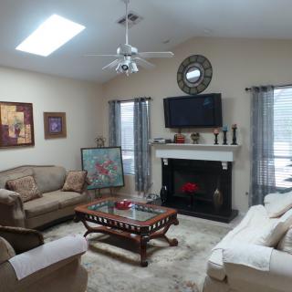 A cozy living room with comfortable sofas, a fireplace, and tasteful decor.