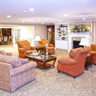 A cozy living room with comfortable seating, a fireplace, and elegant decor.