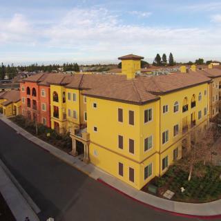 A colorful residential apartment building with vibrant yellow and red facades.