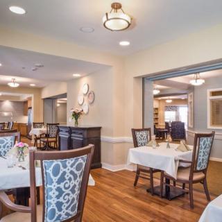 A well-decorated dining room with elegant tables and chairs.