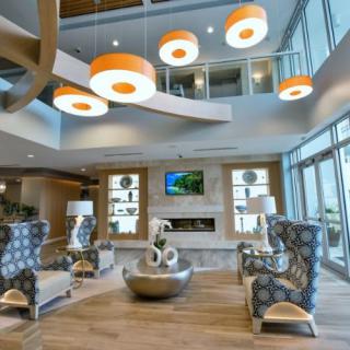 A modern and spacious lounge area featuring contemporary furniture and unique lighting fixtures.
