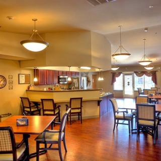 A cozy dining area with arranged tables and warm lighting.