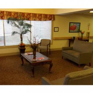 A cozy living room with a sofa, chairs, and a coffee table adorned with decorative items.
