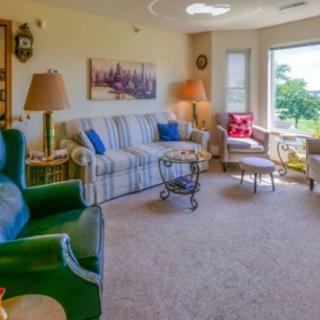 A cozy living room with comfortable seating and a beautiful window view.