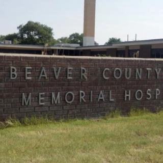 Sign for Beaver County Memorial Hospital in front of a healthcare building.