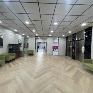A spacious and modern lobby featuring elevators and seating areas.
