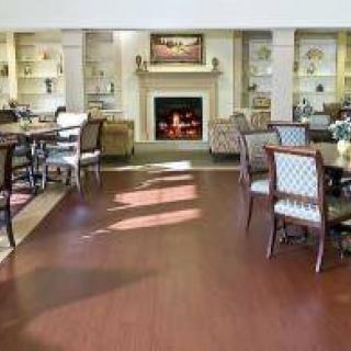 A cozy dining and lounge area with elegant furnishings and a warm fireplace.