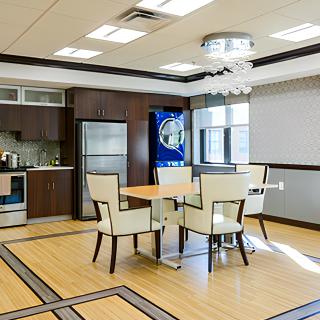 A modern kitchen and dining area with sleek furnishings and appliances.