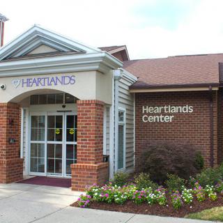 A brick building labeled 'Heartlands Center' with a landscaped entrance.