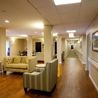 Spacious hallway with seating area and warm lighting.