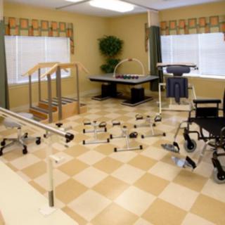 A well-equipped rehabilitation room with various physical therapy equipment.