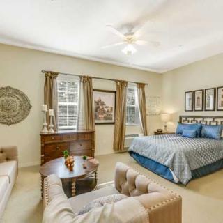 A well-decorated bedroom with elegant furnishings and tasteful artwork.
