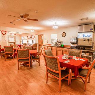 An empty dining area with decorated tables and chairs.