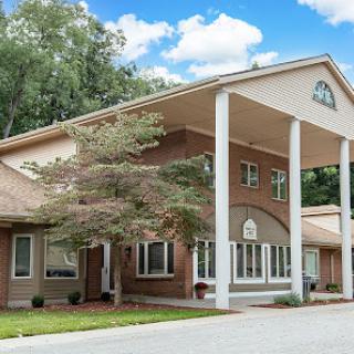 A beautiful residential building showcasing elegant architecture and surrounded by lush greenery.