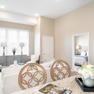 A beautifully designed modern living room with a light color palette and stylish furnishings.