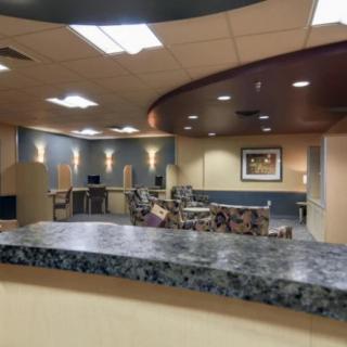 A modern reception area with seating and lighting fixtures.