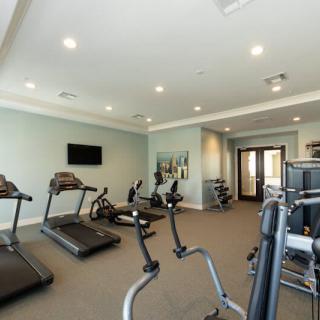 A well-equipped gym with treadmills and stationary bikes.