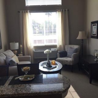 A cozy living room with comfortable seating and soft natural lighting.