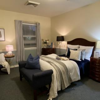 A cozy bedroom with elegant furnishings and ambient lighting.
