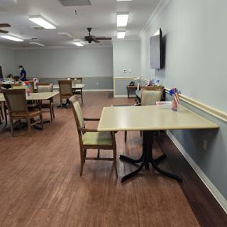 A spacious dining area featuring neatly arranged tables and chairs, designed for communal meals.
