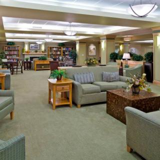 A spacious library interior with comfortable seating and bookshelves.