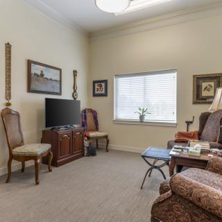 A cozy living room with traditional furniture and a television.