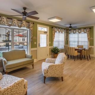 A cozy living room with modern furnishings and wood flooring.