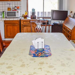 A cozy kitchen with a dining table set for a meal.