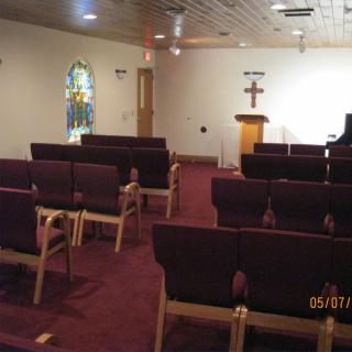 A church interior with rows of seating and a pulpit at the front.