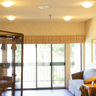 A cozy living room with a sofa and large sliding doors allowing natural light to fill the space.
