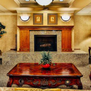 A cozy living room featuring a central fireplace, elegant coffee table, and tasteful decor.