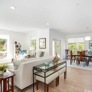 A bright and airy living room featuring modern furnishings and an open layout.