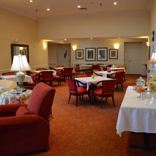 A cozy dining area with tables and chairs set for guests.
